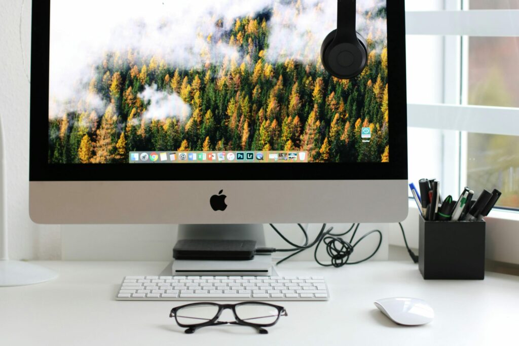 Free Stylish home office workspace featuring a computer setup with accessories. Stock Photo